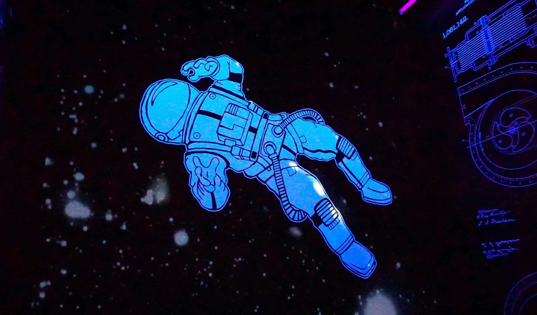 Blue astronaut floating against a dark background.